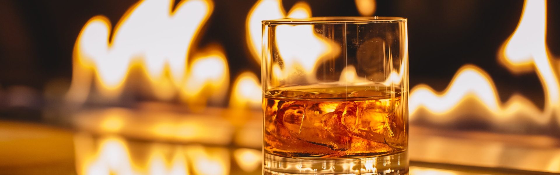 side view of glass of whiskey with ice on a background of a burning flame SSUCv3H4sIAAAAAAAACpyRwW7DIAyG75P2DhHnRgpNG6V9lWoHB9wElUIFZNNU9d1nIFScd8Of7d/+zfPzo2nYBF4Jdm6eMaJYab364CAoawh3u407NBJdTVCqYJ0CXcMJglgM3JGgWbWO+JWSzAcIq0cfh21IQMCZNDJ8S+SNLjluSiIlqYNSjO0q5tcpsYKy+L868+OruIEZjfhNC1dGHGqEbOSSS9ntJ6C719ZglcpWrr6tAB0L+krp4ZRQZq7abFjSlUubsKsJLq7w3pxpax8w6XjiK2li4Qt4T+Wy8GqQoD+192qOsSEZ2FSZpJ+IIe/3PT/uh3HkYz8MnB+2gvx7iyKdtE4RoljclKytq7gBm45yPHbjqeUTDu2h67p2lD22pytKyTt5QiHp8K8/AAAA//8DAFWmtZSHAgAA